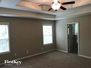 Lawrenceville house for rent - a bedroom with a ceiling fan and a door to a closet