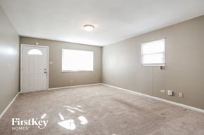 Indianapolis house for rent - a empty room with a white door and a window