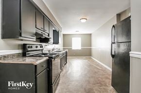 Indianapolis house for rent - an empty kitchen with stainless steel appliances and white walls