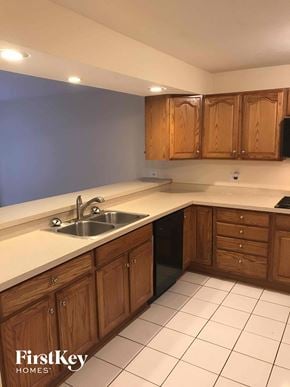 Glenwood house for rent - A kitchen with wooden cabinets and a white countertop.