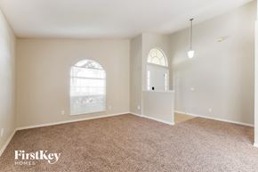 Winter Haven house for rent - A room with a carpeted floor and two windows.