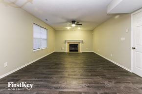 Indianapolis house for rent - the living room with wood floors and a fireplace