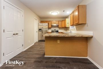 Indianapolis house for rent - a kitchen with a counter top and a refrigerator