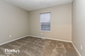 Indianapolis house for rent - a spacious room with carpet and a window