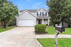 Wentzville house for rent - a white house with a driveway and a mailbox