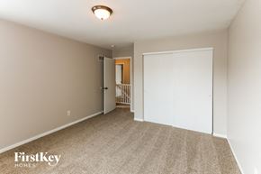 Wentzville house for rent - a bedroom with a closet and a door to a hallway