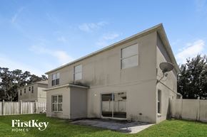 Poinciana house for rent - the exterior of a white house with smoke coming out of it