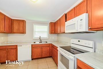 Apopka house for rent - A kitchen with wooden cabinets and white appliances.