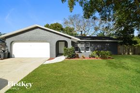 Casselberry house for rent - a gray house with a white garage door and a lawn
