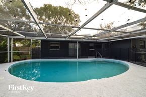 Casselberry house for rent - a swimming pool in the backyard of a house with a pool