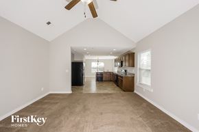 Odenville house for rent - a spacious living room and kitchen with a ceiling fan