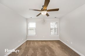 Odenville house for rent - the living room is spacious and clean with a ceiling fan