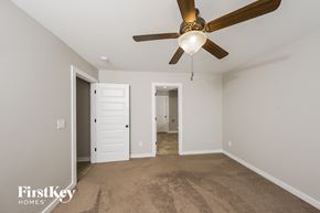 Odenville house for rent - a bedroom with a ceiling fan and a carpeted floor