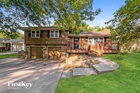 Lee's Summit house for rent - a house with a patio and a driveway in front of it