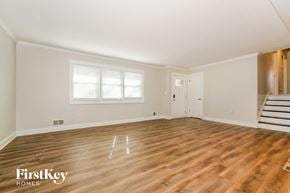 Lee's Summit house for rent - the living room of an empty house with wooden floors and white walls