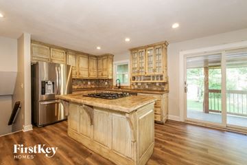 Lee's Summit house for rent - a kitchen with wooden cabinets and a large counter top