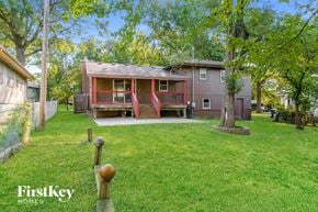 Lee's Summit house for rent - a small red house with a porch and a grassy yard