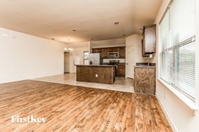 Lancaster house for rent - a kitchen and living room with wood floors and white walls