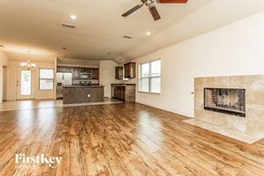 Lancaster house for rent - a kitchen and living room with wood floors and a fireplace