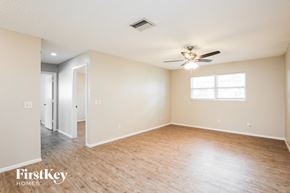 Cape Coral house for rent - A spacious room with a ceiling fan and a window.