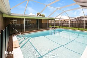 Cape Coral house for rent - A swimming pool under a white roof.