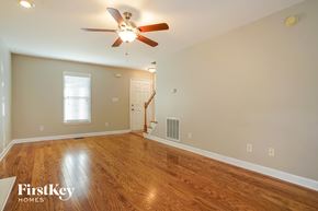 Wake Forest house for rent - A spacious room with a wood floor and a ceiling fan.