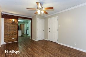 Mansfield house for rent - A room with a ceiling fan and wooden floors.