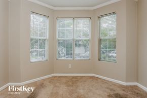 Atlanta house for rent - A room with carpeted floor and three windows.