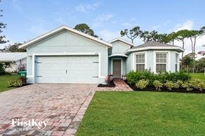 Cape Coral house for rent - A house with a blue garage door is for sale.