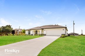 Cape Coral house for rent - a home with a driveway and a garage door
