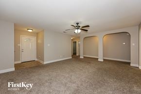 Lancaster house for rent - A spacious room with a ceiling fan and carpeted floor.