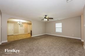 Lancaster house for rent - A spacious room with a ceiling fan and carpeted floor.