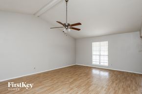 Desoto house for rent - A room with a ceiling fan and wooden flooring.