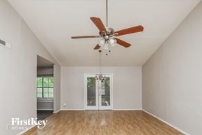Desoto house for rent - A room with a ceiling fan and a door leading to another room.
