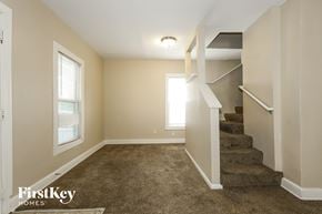 Aurora house for rent - A room with a staircase leading to another room.