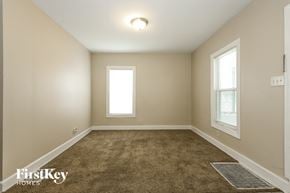 Aurora house for rent - A room with a carpeted floor and a window.