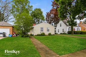 Waukegan house for rent - A residential area with houses and a tree in the foreground.
