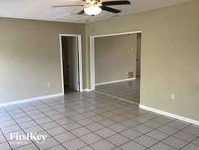 Casselberry house for rent - an empty living room with a ceiling fan