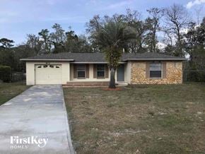 Casselberry house for rent - a home with a driveway and a tree in front of it
