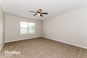 Cape Coral house for rent - a bedroom with carpet and a ceiling fan