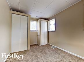 Joliet house for rent - a small bedroom with a closet and a window