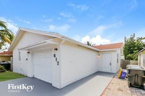 Lake Worth house for rent - A white house with the number 617 on the garage door.