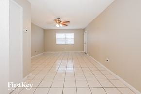 Lake Worth house for rent - A spacious room with a ceiling fan and a window.