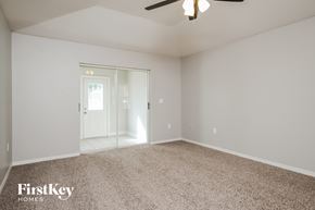 Winter Haven house for rent - a master bedroom with carpet and a door to the bathroom
