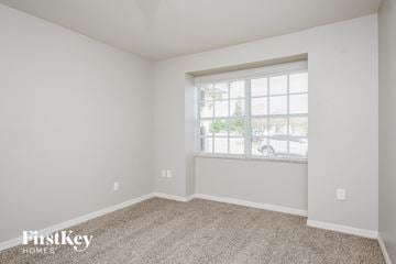 Winter Haven house for rent - a spacious living room with carpet and a window