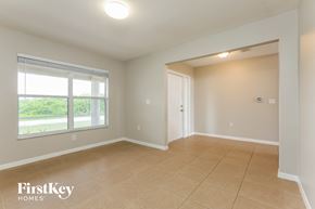 Lehigh Acres house for rent - A room with a sliding glass door and a tiled floor.