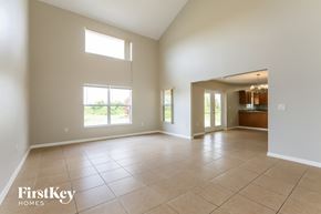 Lehigh Acres house for rent - A spacious room with a tile floor and a large window.