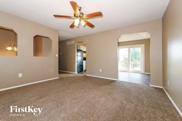Excelsior Springs house for rent - a living room with carpet and a ceiling fan
