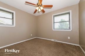 Excelsior Springs house for rent - the master bedroom has a ceiling fan and beige carpet