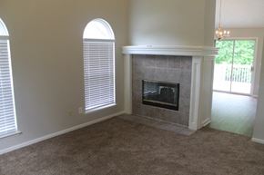 Raymore house for rent - A room with a fireplace and a carpet.